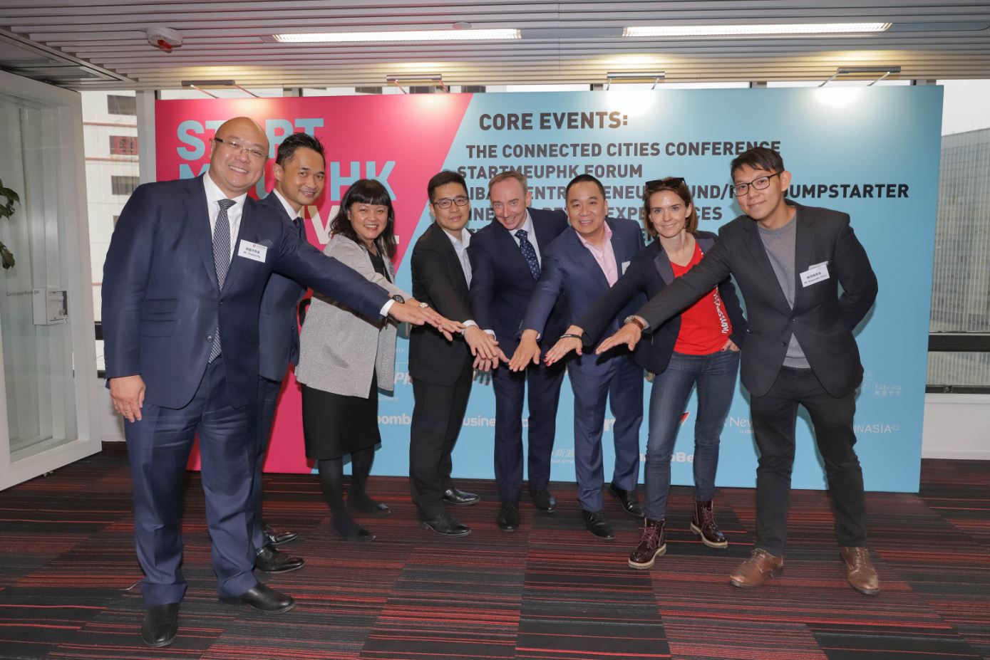 Invest Hong Kong (InvestHK) hosted a media briefing today (20 January 2020) to announce core events of the extended StartmeupHK Festival 2020. From left: Associate Director-General of Investment Promotion at InvestHK Mr Charles Ng; Partner, Smart City Group, KPMG China, Mr Alan Yau; the Head of StartmeupHK at InvestHK, Ms Jayne Chan; the Operations Director of Alibaba Entrepreneurs Fund, Mr Teddy Lui; the Founder and CEO of Bailey Communications HK, Mr Stuart Bailey; the Managing Director of Jumpstart Media, Mr James Kwan; CEO and Co-founder of WHub Ms Karena Belin; and Co-director of the Mills Fabrica Mr Alexander Chan join hands to announce the details of the StartmeupHK Festival 2020.